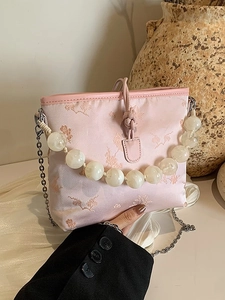 Sac à main rose avec poignée en perles, broderies florales et bandoulière en métal chic