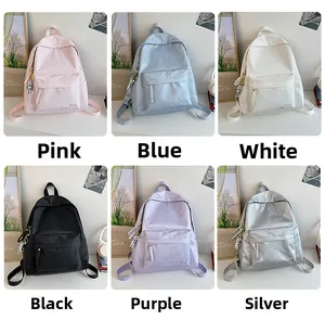Collage of fashion student backpacks in six colors with astronaut pendant charms