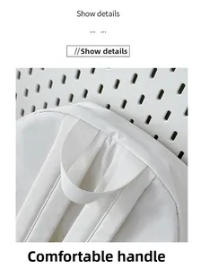 Detail of a white backpack with a durable webbed handle and faint palm leaf patterns