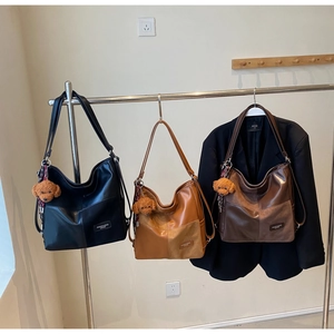 Three multi-color suede velvet tote bags displayed with cute teddy bear plush pendants