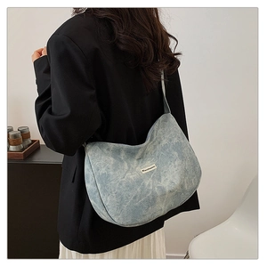 Light blue slouchy hobo bag with corduroy texture shown on model for daily commute style