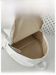Internal display of minimalist cream backpack showing spacious main compartment and pockets