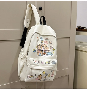 Detail of white canvas backpack featuring cute capybara cartoon prints and black handle