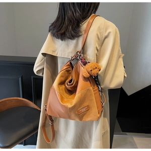 Detail of vintage brown patchwork tote bag with a cute teddy dog plush pendant charm