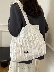 Minimalist white canvas tote bag with black polka dots and pleated detail for women