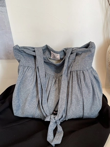 Gray blue denim tote bag with pleated top and long strap handles for daily commute