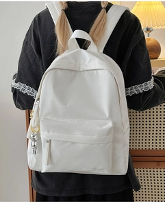 Minimalist white leather backpack for women with silver bear charm and Hoog embroidery