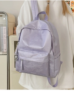 Detail of light purple backpack with satin finish, leaf shadow print and Hoog logo
