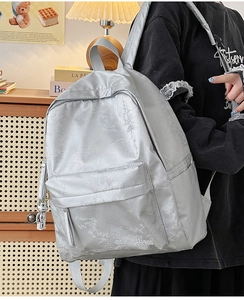 Close-up of silver-gray jacquard backpack featuring bamboo patterns and HOOG logo