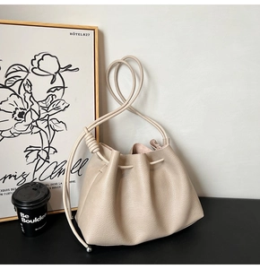 Detail of light coffee drawstring bucket bag with litchi grain and rope strap style