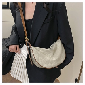 Detail of adjustable leather strap and buckle on the vintage beige half-moon crossbody bag