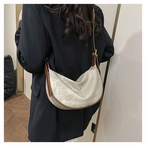 Hobo crescent bag detail with beige matte fabric and dark brown leather contrast trim