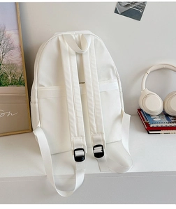 Minimalist white backpack back view showing wide straps and hidden zipper pocket