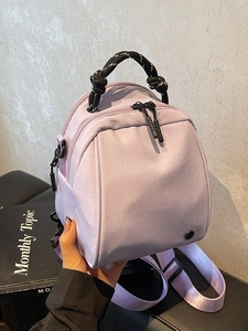 Mini lavender shell-shaped backpack and crossbody bag with rope handle detail