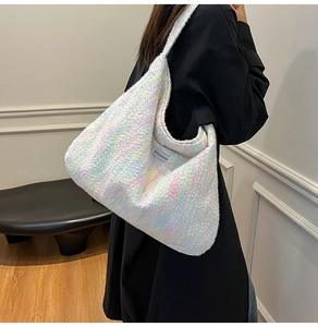 Detailaufnahme der bunten Tweed-Strick-Tasche mit weißem Jellyhouse-Webetikett am Rand