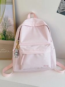 Minimalist light pink waterproof backpack with Hoog embroidery and silver bear charm accessory