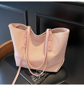 Detail view of pink tote bag showing the fine woven texture and top zipper closure