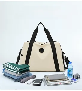 Detailed macro view showing the large capacity of the beige Oxford travel bag with clothes