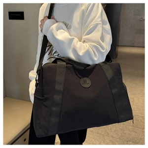 Detail of black waterproof Oxford cloth travel bag with handle and metal zipper