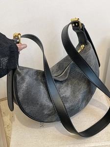 Minimalist grey washed denim crescent crossbody bag with black leather shoulder strap