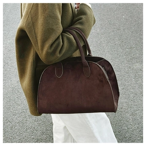 Street style view of a large dark brown matte tote bag with minimalist shoulder straps