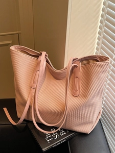 Pink woven tote bag with slim leather straps and zipper closure for daily commute