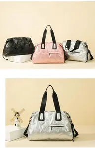 Three-color travel duffle bags in metallic silver, black and pink with V-texture