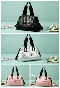 Detail showing high-shine waterproof nylon texture on large gym and travel bags