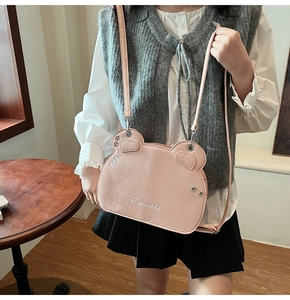Detail of pink bear-shaped crossbody bag with Princess embroidery and heart stitching