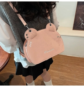Detail of pink bear-shaped crossbody bag with Princess embroidery and matte texture
