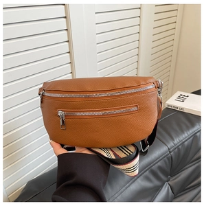 Detail of brown litchi pattern leather waist bag with striped strap and silver zipper