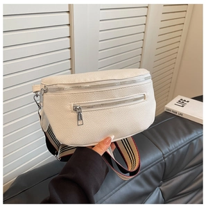 Close-up of white pebble leather waist bag with colorful striped wide fabric strap