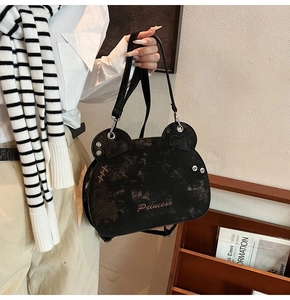 Close-up of bear-shaped backpack with Princess embroidery and vintage leather texture