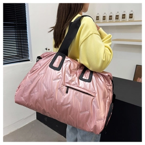 Detail of pink metallic quilted fitness bag with adjustable strap and side pocket