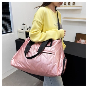 Pink metallic travel bag detail showing side zip pocket and durable nylon texture