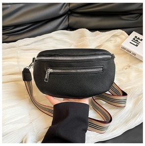 Close-up of black litchi grain leather waist bag with silver zippers and striped strap
