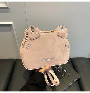 Close-up of pink suede crossbody bag with heart-shaped ears and Princess embroidery