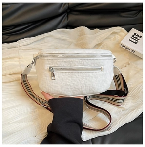 Detail of white lychee leather saddle bag with striped strap and silver hardware