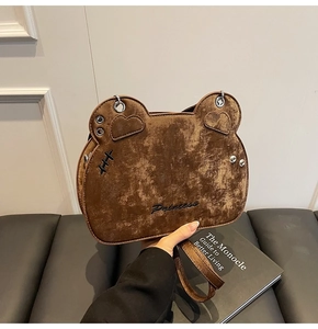 Detailed view of a brown vintage bear-shaped crossbody bag with Princess embroidery