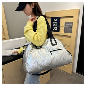 Metallic silver quilted gym bag with black straps and large capacity for travel