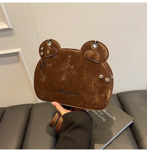 Close-up of bear-shaped faux suede bag featuring heart ears and Princess embroidery