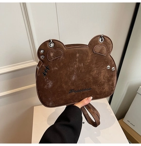 Detail showing plush brown bear-shaped crossbody bag texture and Princess embroidery