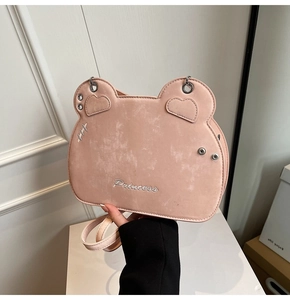 Detailed close-up of pink cat-ear crossbody bag with Princess embroidery and metal hardware