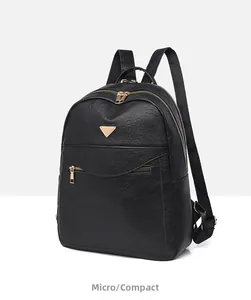 Detailed side view of black faux leather backpack showing pebbled texture and gold zipper