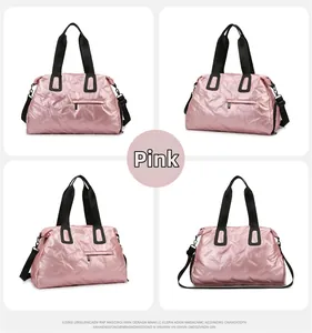 Pink metallic gym bag with geometric diamond embossing and adjustable shoulder strap