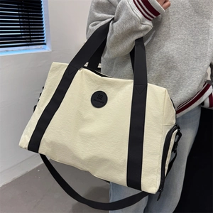 Off-white large capacity oxford travel bag with black straps and side shoe compartment