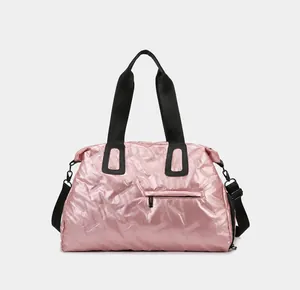 Front view of pink metallic gym bag featuring geometric texture and detachable strap