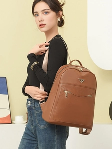 Minimalist brown leather backpack for women with gold zipper and metal triangle logo