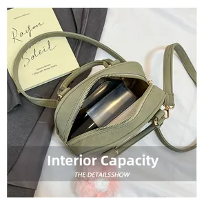 Macro detail of spacious interior capacity and suede texture of the light green handbag