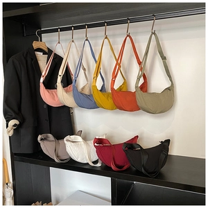 Selection of minimalist nylon crescent bags in various vibrant colors with adjustable straps